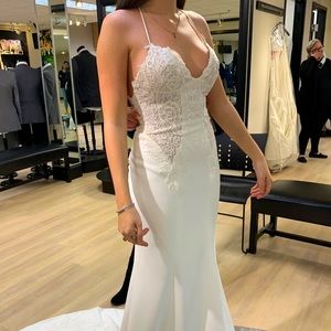 Beautiful spaghetti strap wedding dress with lace and a train.